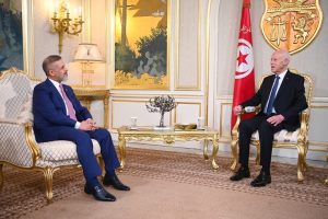 Deputy Prime Minister and Minister of Planning Dr. Mohammed Ali Tamim hands Tunisian President Kais Saied an official invitation to attend the Arab Summit in Baghdad